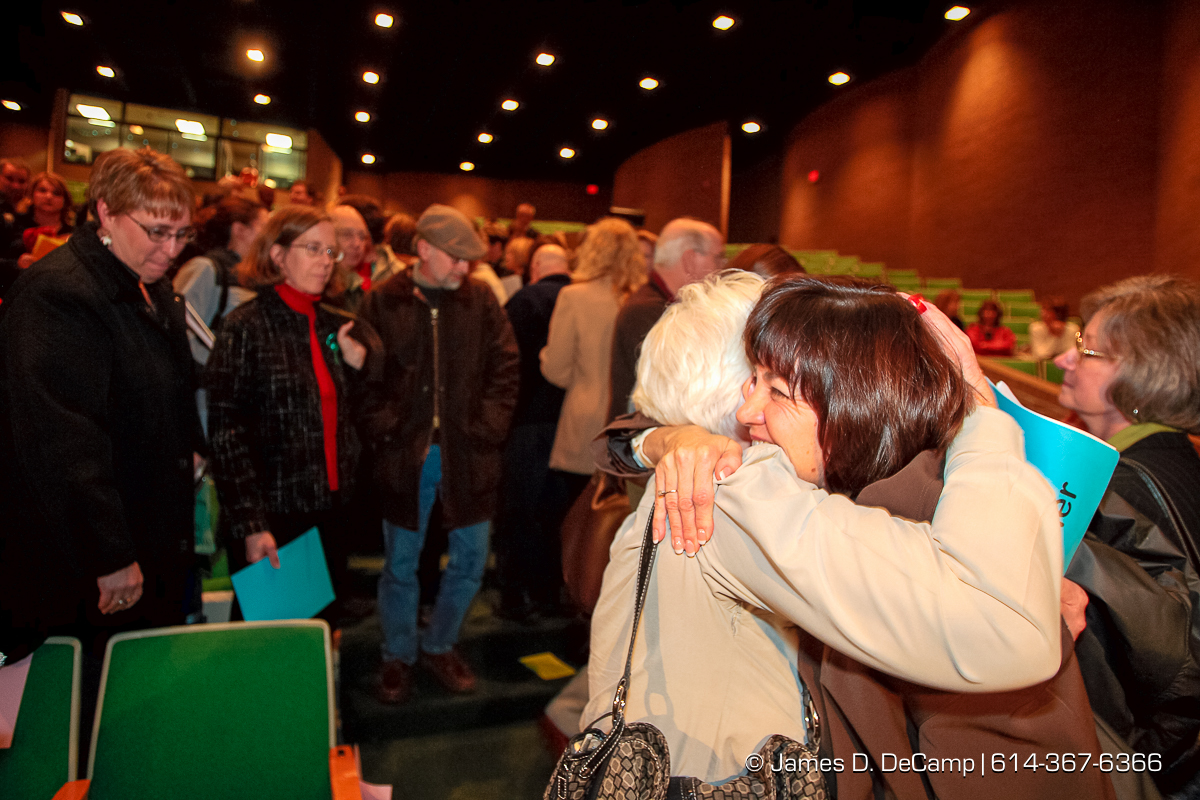 Dr. Linda Fenner, right, in dark coat, gets a hug from former co-worker and friend Connie Barth, in white coat, after being fired at a regular meeting of the Dublin Board of Education held at Dublin Coffman High School's Performing Arts Center Tuesday night December 12, 2006. The agenda for Tuesday night's school board meeting includes two resolutions about Superintendent Linda Fenner and Treasurer Chris Mohr: one to extend their contracts and the other to declare that the board does not intend to retain them. The dueling resolutions reflect the fallout after Fenner and Mohr's once-close relationship disintegrated. Complaints that each filed against the other revealed an instance where they kissed, gushy e-mails Fenner sent Mohr, and the intertwining of their personal and work relationships. Since then, critics have questioned their professionalism while others have stood up to support Mohr or Fenner. "I fear here that what's happened is there has been such a public outcry that the board believes that the easiest way out is just to nonrenew both of them," said Mohr's attorney, Rex Elliott. Fenner's attorney, John Marshall, said the opposite, at least about her fate. "It's pretty clear that there is enormous support for Dr. Fenner in the community. Actually, if it comes to a vote, I'd be surprised if she's not renewed." Fenner has said that she has no intention of resigning. School board President Chris Valentine wouldn't say what the board would do Tuesday but said the members were eager "to put the focus back on the students and the education we provide them." "The board is evaluating all of these factors. Ultimately, this is a very difficult decision." If the board decides to nonrenew either or both officials, they would serve the remainder of their contracts, Valentine said. Fenner's contract expires in July; Mohr has 13 months left on his, Valentine said. (© James D. DeCamp | http://www.JamesDeCamp.com | 614-3