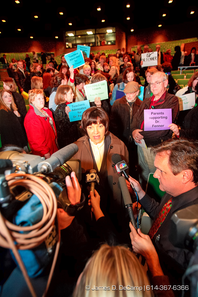 Dr. Linda Fenner talks with the media surrounded by supporters after being fired at a regular meeting of the Dublin Board of Education held at Dublin Coffman High School's Performing Arts Center Tuesday night December 12, 2006. The agenda for Tuesday night's school board meeting includes two resolutions about Superintendent Linda Fenner and Treasurer Chris Mohr: one to extend their contracts and the other to declare that the board does not intend to retain them. The dueling resolutions reflect the fallout after Fenner and Mohr's once-close relationship disintegrated. Complaints that each filed against the other revealed an instance where they kissed, gushy e-mails Fenner sent Mohr, and the intertwining of their personal and work relationships. Since then, critics have questioned their professionalism while others have stood up to support Mohr or Fenner. "I fear here that what's happened is there has been such a public outcry that the board believes that the easiest way out is just to nonrenew both of them," said Mohr's attorney, Rex Elliott. Fenner's attorney, John Marshall, said the opposite, at least about her fate. "It's pretty clear that there is enormous support for Dr. Fenner in the community. Actually, if it comes to a vote, I'd be surprised if she's not renewed." Fenner has said that she has no intention of resigning. School board President Chris Valentine wouldn't say what the board would do Tuesday but said the members were eager "to put the focus back on the students and the education we provide them." "The board is evaluating all of these factors. Ultimately, this is a very difficult decision." If the board decides to nonrenew either or both officials, they would serve the remainder of their contracts, Valentine said. Fenner's contract expires in July; Mohr has 13 months left on his, Valentine said. (© James D. DeCamp | http://www.JamesDeCamp.com |