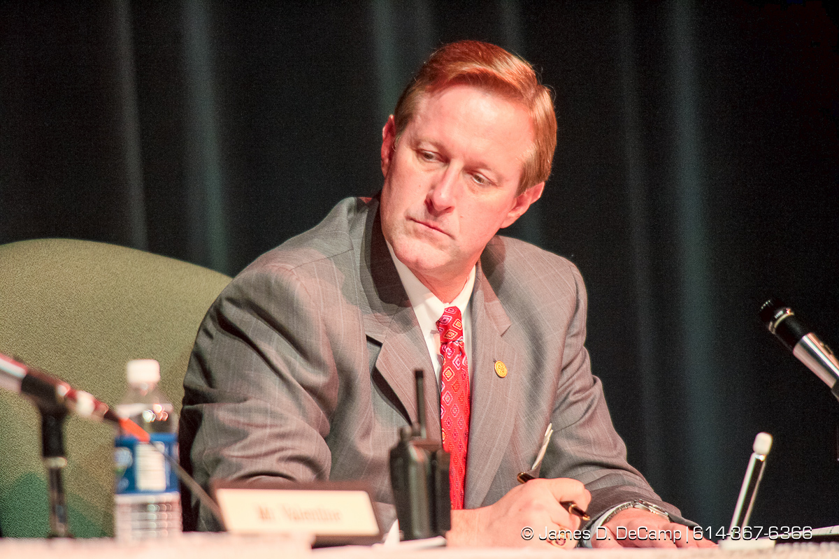 Chris Mohr, Treasurer/Director of Business and Finance listens to remarks at a regular meeting of the Dublin Board of Education held at Dublin Coffman High School's Performing Arts Center Tuesday night December 12, 2006. The agenda for Tuesday night's school board meeting includes two resolutions about Superintendent Linda Fenner and Treasurer Chris Mohr: one to extend their contracts and the other to declare that the board does not intend to retain them. The dueling resolutions reflect the fallout after Fenner and Mohr's once-close relationship disintegrated. Complaints that each filed against the other revealed an instance where they kissed, gushy e-mails Fenner sent Mohr, and the intertwining of their personal and work relationships. Since then, critics have questioned their professionalism while others have stood up to support Mohr or Fenner. "I fear here that what's happened is there has been such a public outcry that the board believes that the easiest way out is just to nonrenew both of them," said Mohr's attorney, Rex Elliott. Fenner's attorney, John Marshall, said the opposite, at least about her fate. "It's pretty clear that there is enormous support for Dr. Fenner in the community. Actually, if it comes to a vote, I'd be surprised if she's not renewed." Fenner has said that she has no intention of resigning. School board President Chris Valentine wouldn't say what the board would do Tuesday but said the members were eager "to put the focus back on the students and the education we provide them." "The board is evaluating all of these factors. Ultimately, this is a very difficult decision." If the board decides to nonrenew either or both officials, they would serve the remainder of their contracts, Valentine said. Fenner's contract expires in July; Mohr has 13 months left on his, Valentine said. In July, he filed a complaint with the district, saying Fenner was sexually harassing him. (© James D. DeCamp | http://www.JamesDeCamp.c