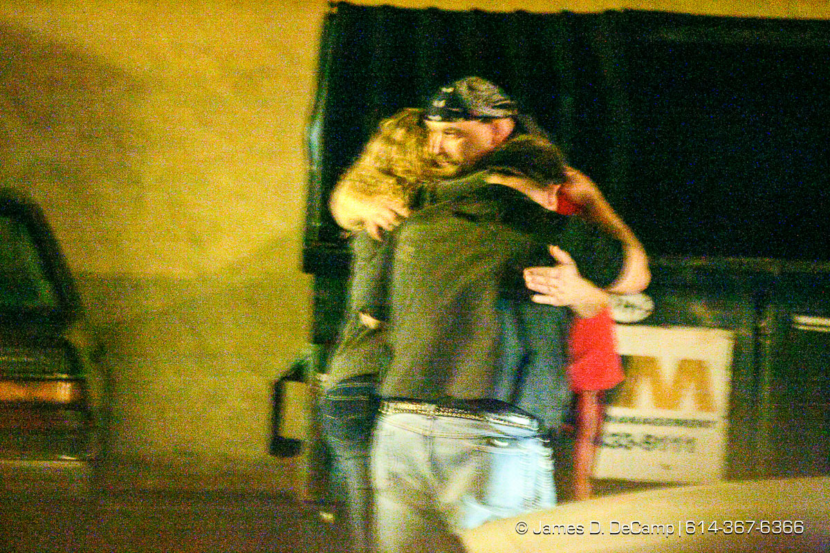 People hug in the parking lot as Columbus, Worthington & Clinton Twp Medics work on one of seven shooting victims at the Alrosa Villa, 5055 Sinclair Road late Wednesday night December 8, 2004. (© James D. DeCamp | http://www.JamesDeCamp.com | 614-367-6366)