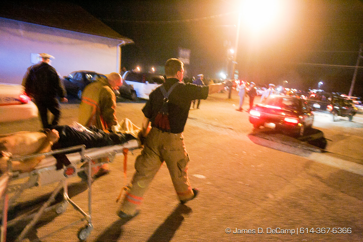 Columbus, Worthington & Clinton Twp Medics transport one of seven shooting victims at the Alrosa Villa, 5055 Sinclair Road late Wednesday night December 8, 2004. (© James D. DeCamp | http://www.JamesDeCamp.com | 614-367-6366)