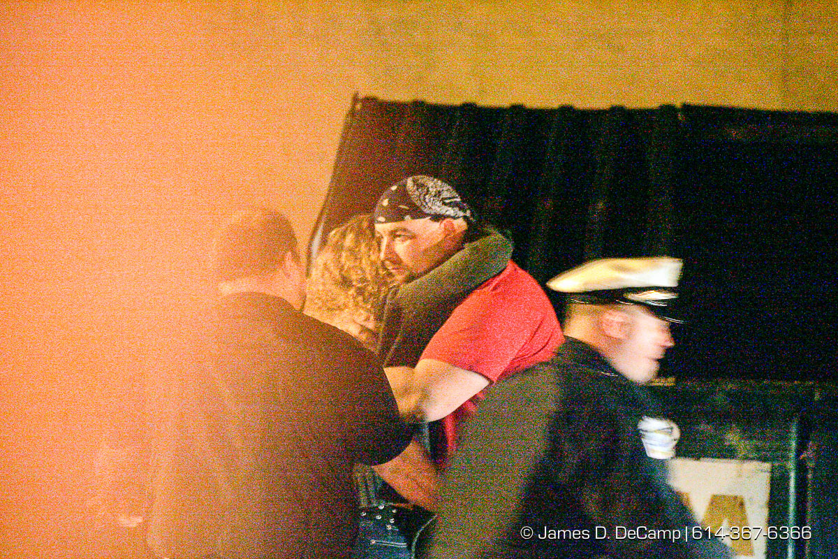 People hug in the parkinglot as Columbus, Worthington & Clinton Twp Medics work on one of seven shooting victims at the Alrosa Villa, 5055 Sinclair Road late Wednesday night December 8, 2004. (© James D. DeCamp | http://www.JamesDeCamp.com | 614-367-6366)