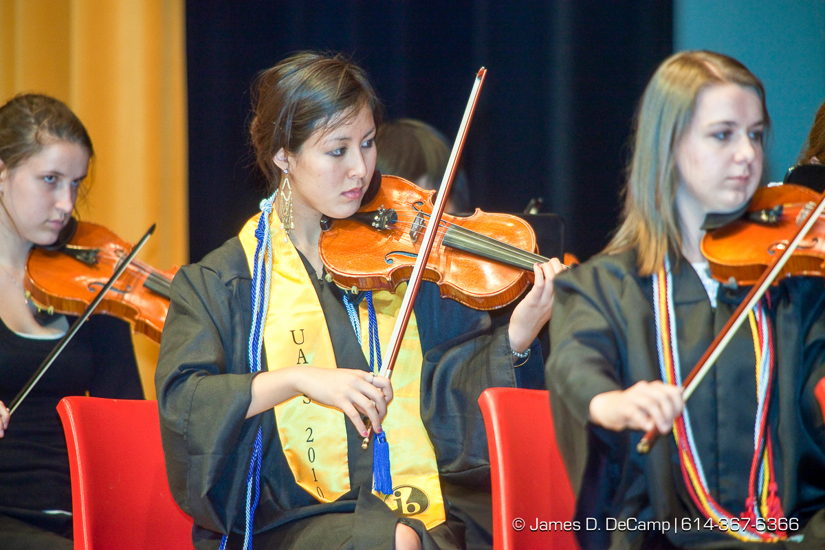 Jane Ting Tsai, with yellow, performs with the UAHS Symphony Orchestra at the Upper Arlington High School Graduation Ceremony held Sunday afternoon June 6, 2010 at the Veterans Memorial Auditorium in Downtown Columbus. (© James D. DeCamp | http://JamesDeCamp.com | 614-367-6366)