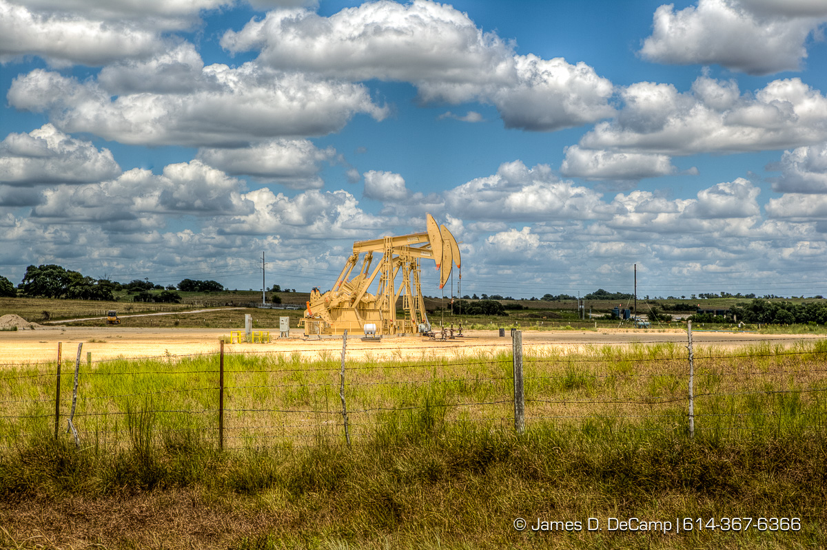 Oil wells working in the scub brush of Lavaca County Texas photographed Wednesday August 3, 2016. (© James D. DeCamp | http://www.JamesDeCamp.com | 614-367-6366)