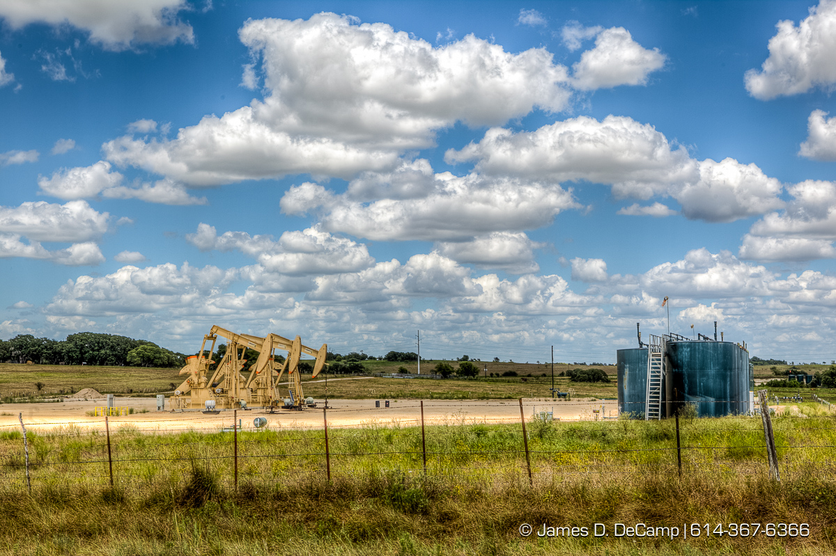 Oil wells working in the scub brush of Lavaca County Texas photographed Wednesday August 3, 2016. (© James D. DeCamp | http://www.JamesDeCamp.com | 614-367-6366)