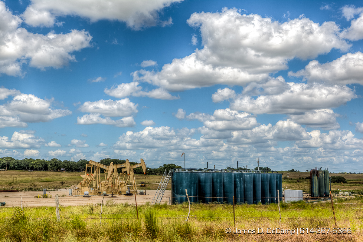 Oil wells working in the scub brush of Lavaca County Texas photographed Wednesday August 3, 2016. (© James D. DeCamp | http://www.JamesDeCamp.com | 614-367-6366)