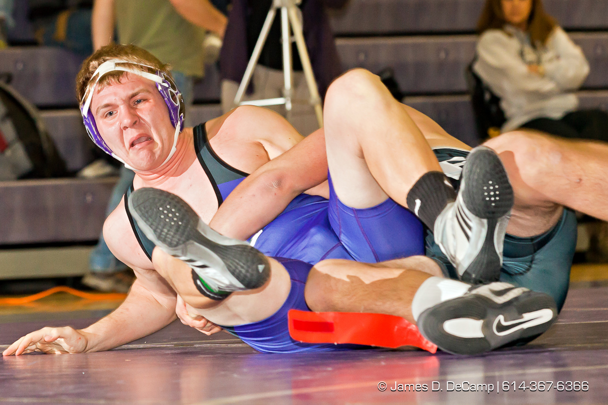 Pickerington North High School's Geno Rollo wrestles with Pickerington Central High School's Ryan Schmeltzer in the 220 lb. weight class Thursday evening February 2, 2012 at Pickerington North High School. (© James D. DeCamp | http://www.JamesDeCamp.com | 614-367-6366)