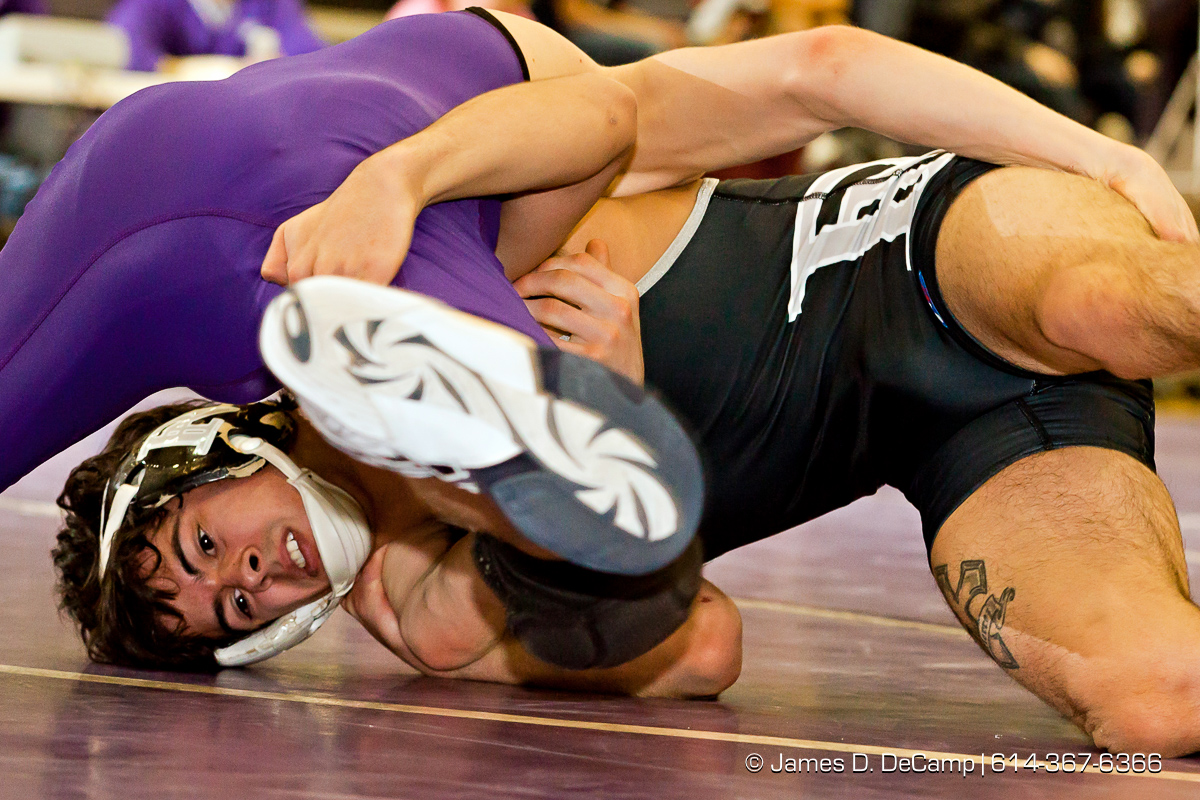 Pickerington North High School's Payton Gutierrez wrestles with Pickerington Central High School's Ryan Mcelwee in the 106 lb. weight class Thursday evening February 2, 2012 at Pickerington North High School. (© James D. DeCamp | http://www.JamesDeCamp.com | 614-367-6366)