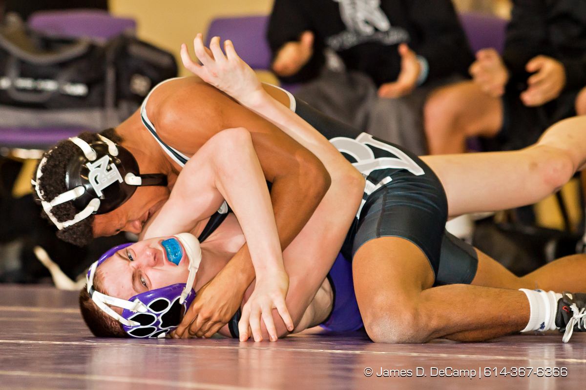 Pickerington North High School's Ahmad Taylor wrestles with Pickerington Central High School's Tyler Hogue in the 113 lb. weight class Thursday evening February 2, 2012 at Pickerington North High School. (© James D. DeCamp | http://www.JamesDeCamp.com | 614-367-6366)