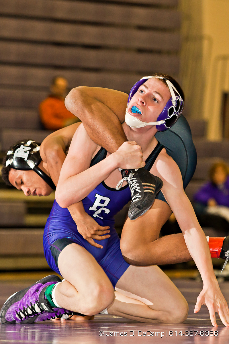 Pickerington North High School's Ahmad Taylor wrestles with Pickerington Central High School's Tyler Hogue in the 113 lb. weight class Thursday evening February 2, 2012 at Pickerington North High School. (© James D. DeCamp | http://www.JamesDeCamp.com | 614-367-6366)