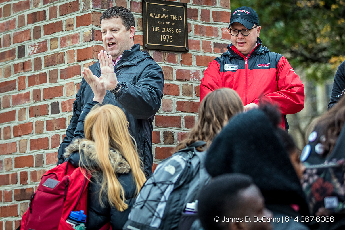 Ohio Wesleyan University students are welcomed by facility Dwayne Todd, Vice President for Student Engagement and Success, left with a high five, and Brad Puccini, Assistant Dean for Student Engagement / Director of First -Year Experience, red coat, during the "Finish Strong OWU"! event photographed Wednesday, October 26, 2016 at the Ohio Wesleyan University gate. (© James D. DeCamp | http://JamesDeCamp.com | 614-367-6366) Ohio Wesleyan University students are welcomed by facility Dwayne Todd, Vice President for Student Engagement and Success, left with a high five, and Brad Puccini, Assistant Dean for Student Engagement / Director of First -Year Experience, red coat, during the "Finish Strong OWU"! event photographed Wednesday, October 26, 2016 at the Ohio Wesleyan University gate. (© James D. DeCamp | http://JamesDeCamp.com | 614-367-6366)