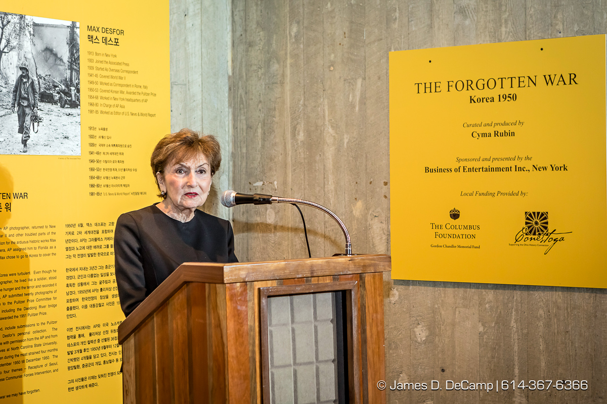 The ribbon cutting of The Forgotten War, Korea 1950, Photographs by Max Desfor photographed Friday, November 11, 2016 at the Ohio History Center. The Ohio History Center has the honor of presenting, for the first time ever in the United States, THE FORGOTTEN WAR, Korea 1950, Photographs by Max Desfor. The extraordinary exhibit of Korean War photographs taken by Pulitzer Prize-winning Associated Press photographer Max Desfor who spent three turbulent years in Korea from 1950–1953. He captured the people’s plight and the American soldiers’ defense. The exhibit features 36 photographs printed from original material culled from Desfor’s personal collection and his 1950 winning submission to the Pulitzer Prize Committee. Curated and produced by Cyma Rubin. Sponsored and presented by Business of Entertainment Inc., New York. Local funding provided by the Gordon Chandler Memorial Fund of The Columbus Foundation and Conestoga, a volunteer fundraising support group. (© James D. DeCamp | http://JamesDeCamp.com | 614-367-6366)