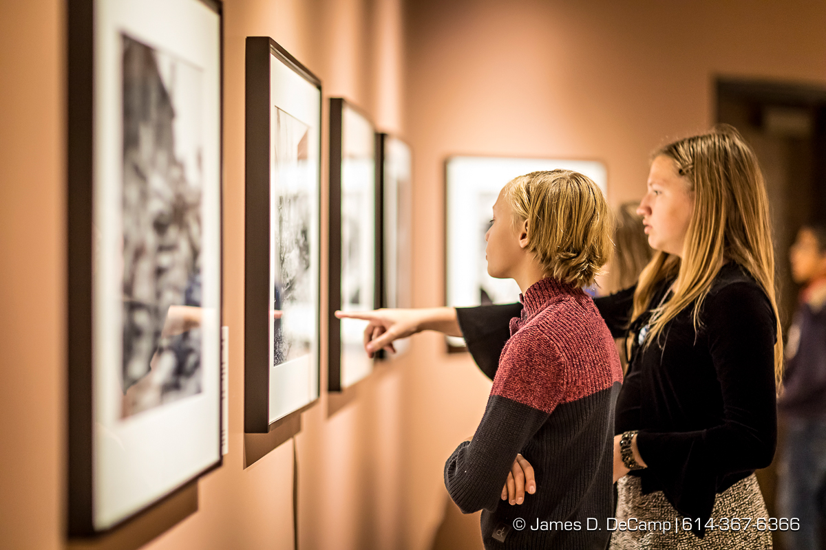The ribbon cutting of The Forgotten War, Korea 1950, Photographs by Max Desfor photographed Friday, November 11, 2016 at the Ohio History Center. The Ohio History Center has the honor of presenting, for the first time ever in the United States, THE FORGOTTEN WAR, Korea 1950, Photographs by Max Desfor. The extraordinary exhibit of Korean War photographs taken by Pulitzer Prize-winning Associated Press photographer Max Desfor who spent three turbulent years in Korea from 1950–1953. He captured the people’s plight and the American soldiers’ defense. The exhibit features 36 photographs printed from original material culled from Desfor’s personal collection and his 1950 winning submission to the Pulitzer Prize Committee. Curated and produced by Cyma Rubin. Sponsored and presented by Business of Entertainment Inc., New York. Local funding provided by the Gordon Chandler Memorial Fund of The Columbus Foundation and Conestoga, a volunteer fundraising support group. (© James D. DeCamp | http://JamesDeCamp.com | 614-367-6366)