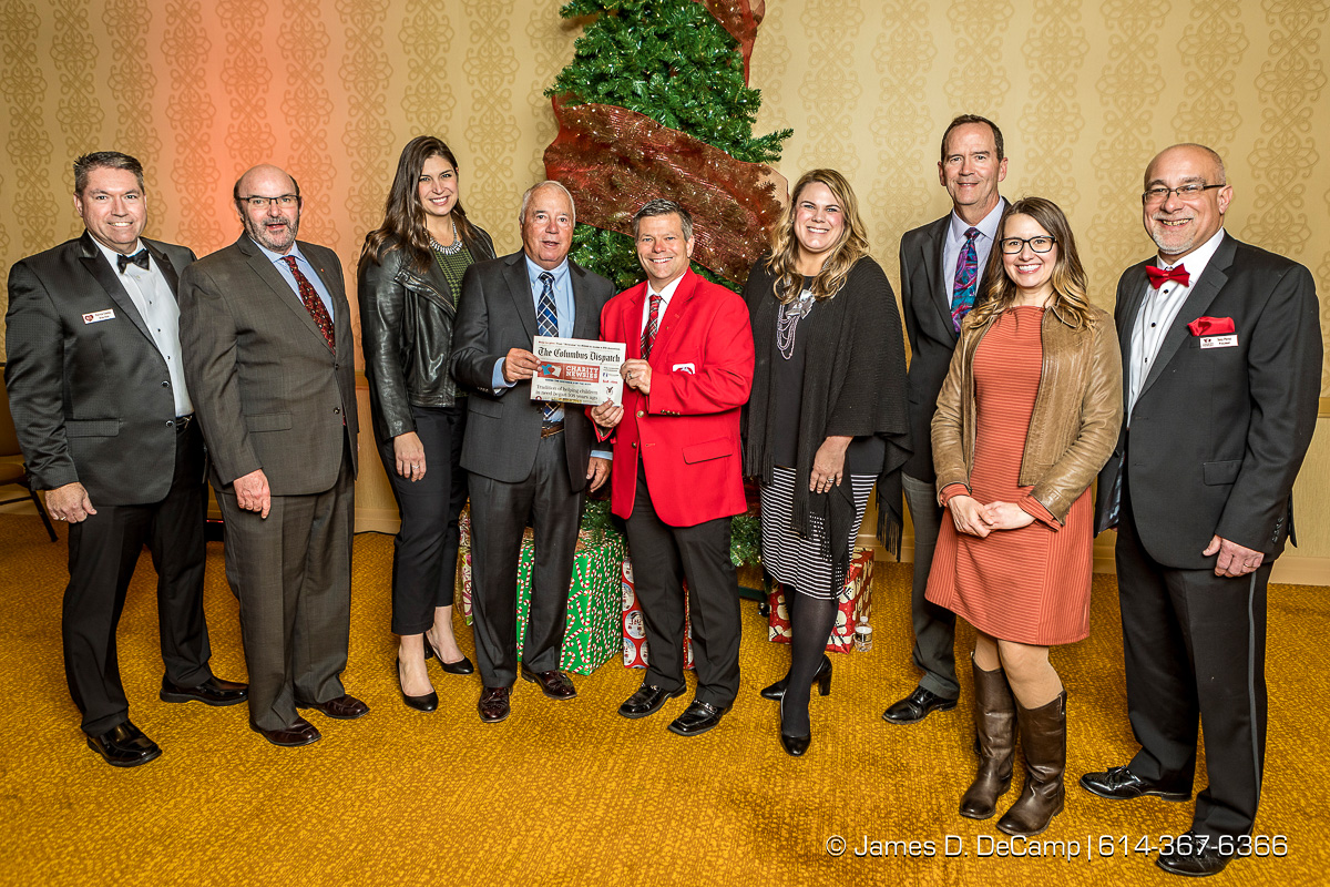 The first newspaper in the The 2017 Clothe-a-Child Gala and 110th annual Charity Newsies Newspaper Auction was sold to Nationwide Insurance: (l-r) Pat Conley, Stephen Chandler, AuBree Lucas, Jim Simpson, Kirk Smith, Allyson Lash, Jim Guinan, Jody Geiger, and Tony Perez photographed Thursday, November 30, 2017 at the Hollywood Casino Ballroom. (© James D. DeCamp | http://JamesDeCamp.com | 614-367-6366)