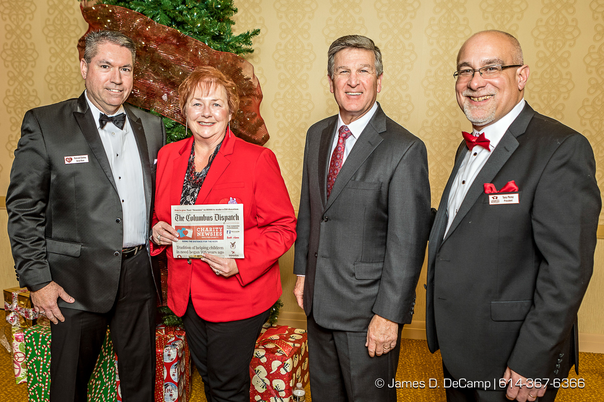The third newspaper in the The 2017 Clothe-a-Child Gala and 110th annual Charity Newsies Newspaper Auction was sold to CompManagement: (l-r) Pat Conley, Kathy Redmond, Randy Jones and Tony Perez photographed Thursday, November 30, 2017 at the Hollywood Casino Ballroom. (© James D. DeCamp | http://JamesDeCamp.com | 614-367-6366)